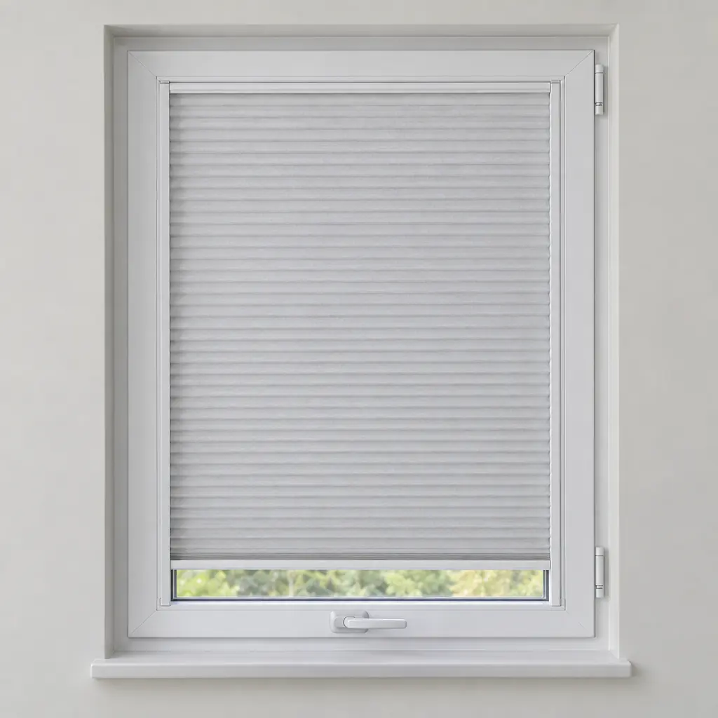A white perfect fit pleated blind in a slim frame clipped into a uPVC tilt-and-turn window, with the window handle below